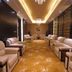Tian Xing Hotel Chongqing lounge with beige armchairs, patterned carpet, and chandelier lighting