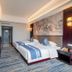 Redstar Culture Hotel Hangzhou guest room with twin beds, wall art, TV and modern lighting