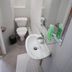 Hotel Rachel bathroom in Le Pré-Saint-Gervais with toilet, sink, mirror and shower area