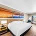 Days Inn by Wyndham Rockdale Texas guest room with king bed, TV, window, and wood furniture