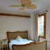 Ibri Hotel in Selçuk guest room with carved wood bed, window, ceiling fan, and patterned rug