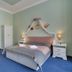 Aphrodite Hotel Marianske Lazne guest room with king bed and blue carpet in Mariánské Lázně