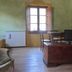 Agriturismo Podere Pratovecchio in Montefollonico room with window, TV, wooden desk and armchairs