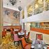 Hilton Suites Jabal Omar Makkah in Mecca lobby restaurant with orange seating and buffet counter