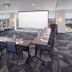 Hyatt House Augusta Downtown meeting room with conference table, projector screen and city views