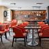 The Lincoln Marriott Cornhusker Hotel in Lincoln dining area with red chairs and modern tables