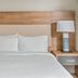 Candlewood Suites Port Arthur/Nederland by IHG guest room with king bed and bedside lamps in Nederland