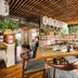 Il Mondo Boutique Hotel Brisbane restaurant with wooden tables, bar seating and warm wood ceiling