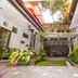 Rumah Asri Bed And Breakfast Bandung interior courtyard with open-air seating and greenery