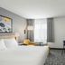 City Express by Marriott Bemidji guest room with king bed, TV, chair and window seating in Bemidji