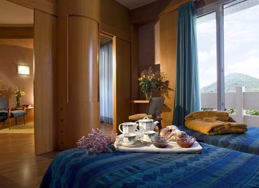 Hotel Terme Orvieto room with twin beds, tea service, and balcony view in Abano Terme