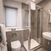 Steventon House Hotel in Abingdon bathroom with shower enclosure, sink, toilet, and towel rail