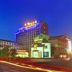 Gold River Side Hotel in Jiaxing at night with neon-lit facade and light trails