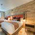 Hotel Lexen Newhall in Newhall guest room with two twin beds, exposed brick wall and window shutters