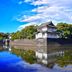 Oakhostel Zen in Tokyo with a traditional castle reflected in calm water