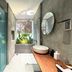 Diamond Star Hotel in Vung Tau bathroom with freestanding sink, wood vanity, turquoise door and garden view