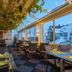 Hotel Toggenburg in Wildhaus dining room with glass roof, hanging greenery, and mountain views