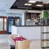 Hotel Surf Mar in Lloret de Mar restaurant with bar, tables set for dining and modern open partition