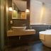 Hotel Pharos Seoul bathroom with freestanding bathtub, vessel sink, and window blinds
