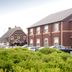 Premier Inn Glasgow - Paisley hotel exterior in Paisley with parked cars and Phoenix Park sign