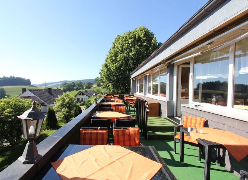 Alpina Löwen Hotel in Sankt Märgen terrace with outdoor tables and scenic countryside views