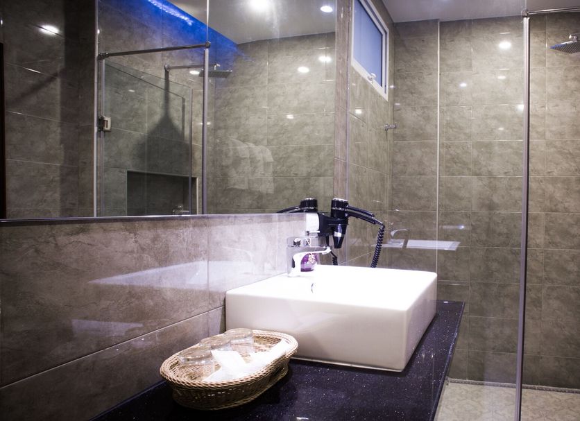 Family Boutique Hotel, Vientiane bathroom with glass shower, vessel sink and stone vanity