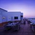 Ginger Jaipur rooftop terrace at dusk with outdoor seating and city views in Jaipur