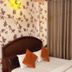 Om Mandakini Hotel Kathmandu guest room with double bed, floral wallpaper and curtains