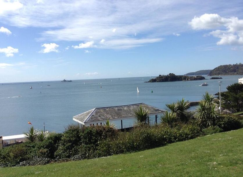 Citadel House Hotel in Plymouth with sea view, grassy garden, and coastal shoreline