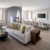Marriott Jacksonville Downtown suite with city view, seating area, dining table and wall-mounted TV in Jacksonville