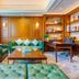 Hulunbeier Hotel in Hulunbuir lounge with teal sofas, coffee table and built-in bookshelf
