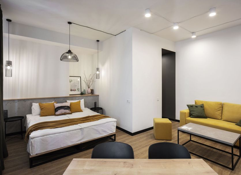 Kantar Hotel Yerevan room with bed, sofa, coffee table and pendant lights
