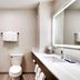 Holiday Inn Express & Suites Helena bathroom with tub, toilet, vanity sink and lit mirror
