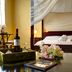 Elia Hotel & Spa in Kolymvari room with canopy bed, seating area, and wine tray