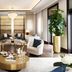 Jumeirah Dar Al Masyaf Dubai lounge with white armchairs, gold coffee table and tall potted plant
