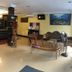 Sipadan Inn 1, Semporna lobby with front desk, seating area, wall art and standing fan