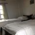 Tushita Nepal Yoga Retreat Center in Pokhara, guest room with three single beds and window light
