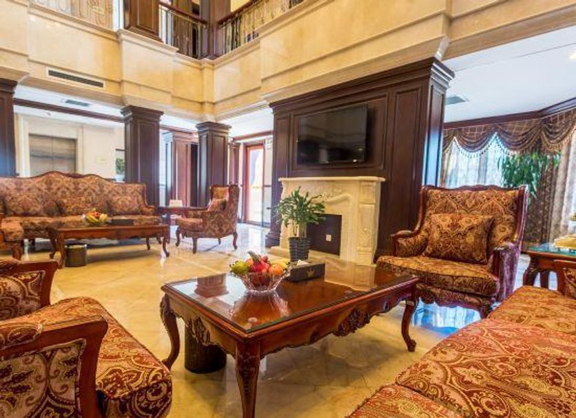 Beijing Jinyu Badaling Resort in Beijing lobby with ornate seating, coffee table, and wall-mounted TV