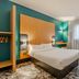 B&B HOTEL Maubeuge-Louvroil room with double bed, teal walls and large window in Louvroil