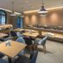 Home Inn Dalian Jinzhou Railway Station Stadium restaurant with tables, blue chairs, and buffet counter