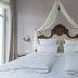 Hotel Weisses Haus, Bad Kissingen: elegant twin bed with ornate carved headboard and draped canopy