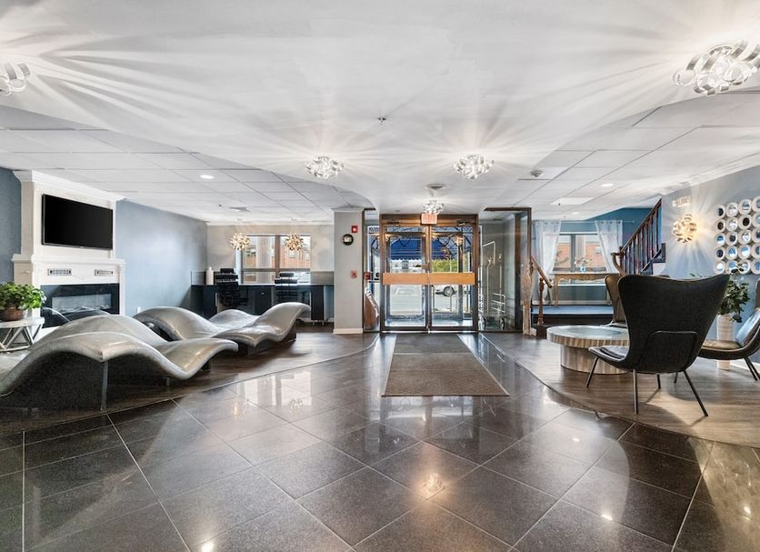 Lakeside Inn Wakefield lobby with seating area, glass entrance doors and polished tile floor