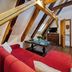 Hotel Svambersky dum in Český Krumlov attic suite with red sofa and exposed wooden beams