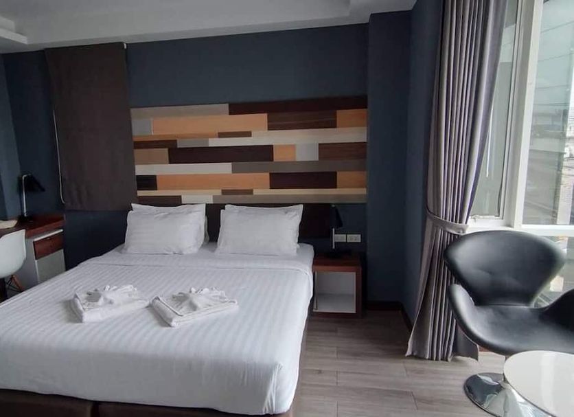Campagne Hotel And Residence - Sha Plus guest room with double bed and city view in Pathum Thani