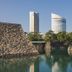 JR Hotel Clement Takamatsu in Takamatsu with waterfront view of stone walls, trees, and city towers