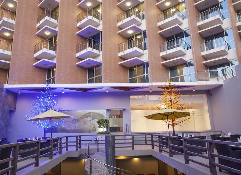 Long Beach Hotel in Cox’s Bāzār courtyard with balconies and lit umbrellas