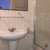 Agriturismo Cerrolungo bathroom with sink, mirror shelf, and glass-enclosed shower in La Spezia