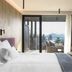 Hotel Olangerhof in Valdaora room with balcony, mountain view, bed, sofa and seating area