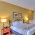 Country Inn & Suites by Radisson, Crystal Lake, IL guest room with king bed and sofa bed