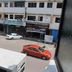 View from Skudai Baru Hotel in Skudai of a street with parked cars and shopfronts